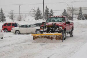 snow plow on front of truck used for snow removal